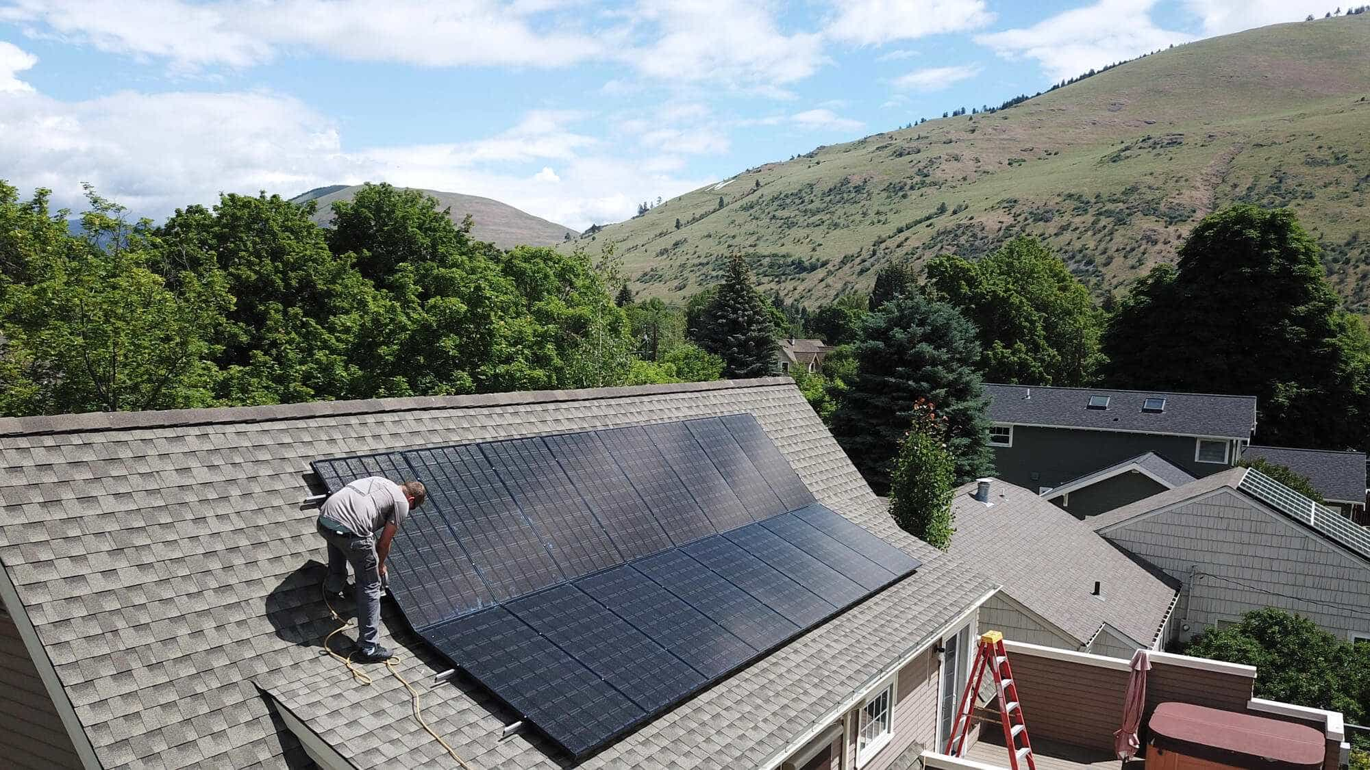 Solar panels being installed on roof