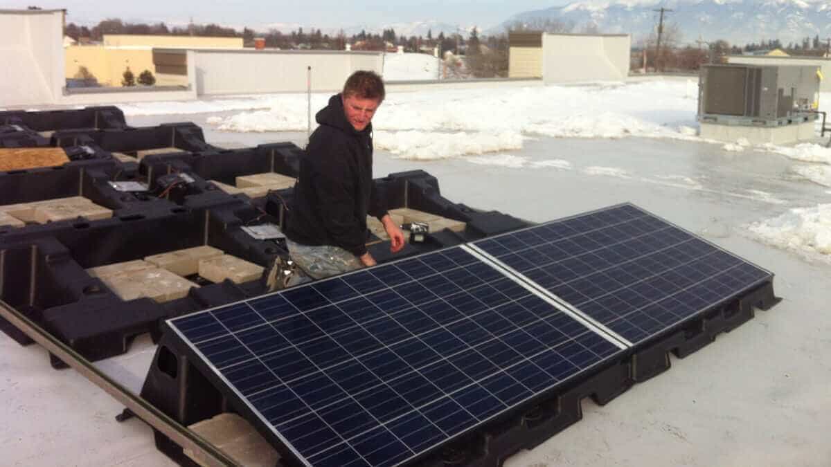 Solar panels being installed by an apprentice
